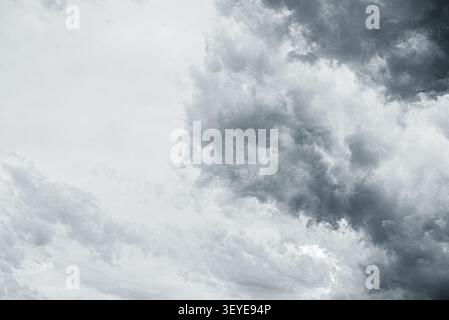 Dark storm clouds gather across a dramatic and overcast sky. Stock Photo