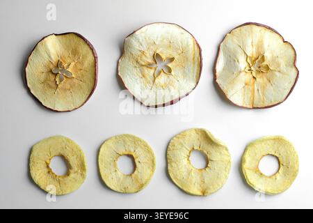 Dried apple slices and rings arranged on clean white background with soft shadows Stock Photo