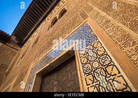 Intricate tile work and stucco carving on the wall and archway at the Alhambra in Granada, Andalusia, Spain Stock Photo