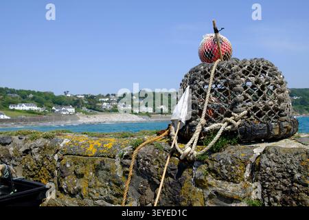 Coverack a harbour and fishing village on the Lizard Peninsula Cornwall UK Crab pot on the harbour wall Stock Photo