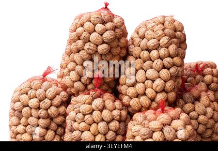 walnuts in red mesh sacks isolated on white background Stock Photo