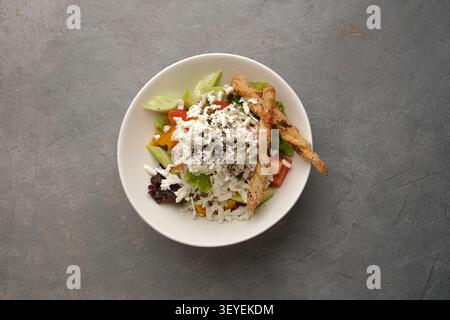 Fresh mixed vegetable salad with crumbled cheese and puff pastry twists in bowl Stock Photo