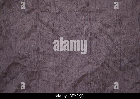 Wrinkled brown fabric texture background with creases and subtle grain for design use Stock Photo