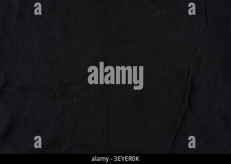 Close-up of black fabric showing lint, creases and soft fibers; ideal as a seamless background or texture for design, fashion, product mockups and edi Stock Photo