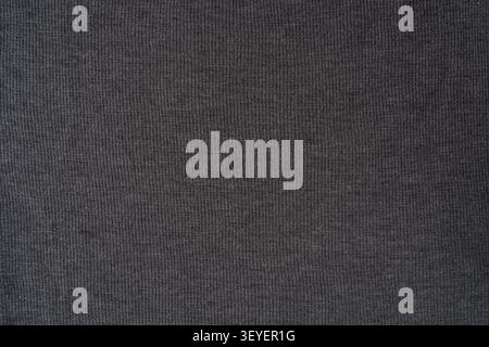 Close-up of dark gray ribbed knit fabric showing fine vertical texture and soft fibers, ideal as a neutral background or textile detail for fashion, u Stock Photo