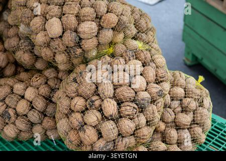 close up of walnuts in mesh sacks at a street market Stock Photo