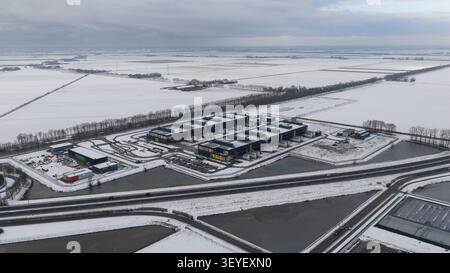 Aerial view of large scale data centers in winter snow, showcasing big tech, big data storage and commercial high-performance computing infrastructure Stock Photo
