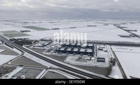 Aerial view of large scale data centers in winter snow, showcasing big tech, big data storage and commercial high-performance computing infrastructure Stock Photo