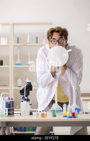 Funny crazy chemist doing experiments and tests Stock Photo