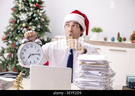 Young worker working in office on christmas shift Stock Photo