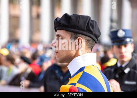 A close-up profile portrait of a Swiss Guard with an earpiece at St. Peter's Square in Vatican. Soldier's face, security and protection concept. Stock Photo