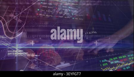 Woman's hands landing on keyboard and typing, activating animated charts, code, binary for finance Stock Photo