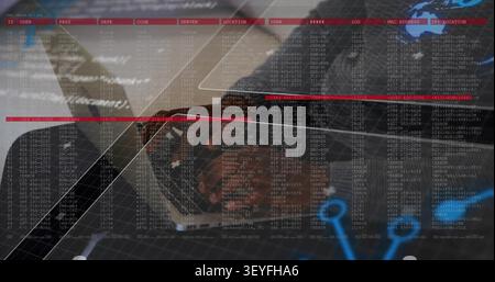 Woman typing on silver laptop and generating scrolling code overlays while monitoring network Stock Photo