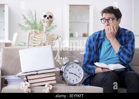 Student studying with skeleton preparing for exams Stock Photo