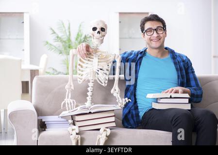 Student studying with skeleton preparing for exams Stock Photo