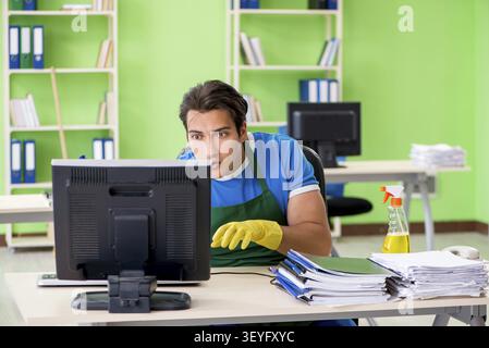 Hacker under professional cleaner cover stealing personal data Stock Photo