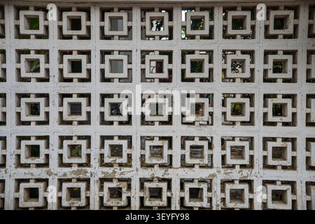 Decorative concrete breeze block wall with repeating square pattern Stock Photo