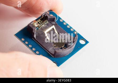 Real Time Clock Module For AVR ARM PIC Tiny RTC I2C modules memory DS1307 Clock in hand Stock Photo