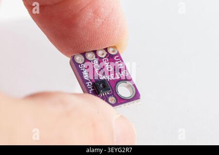 Temperature and pressure sensor for a DIY smart home held in hand Stock Photo