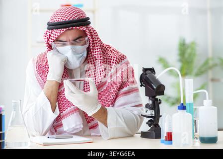 Arab doctor chemist studying new virus in lab Stock Photo