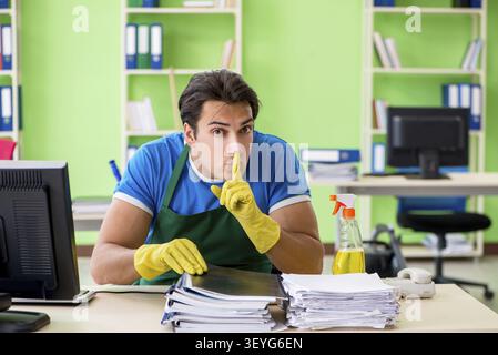 Male spy under cleaner cover stealing confidential documents Stock Photo