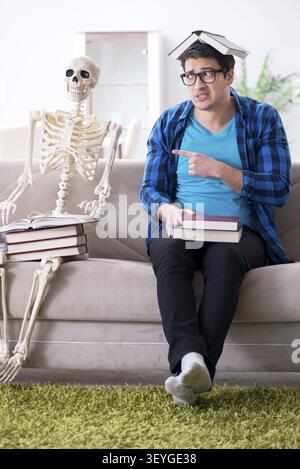 Student studying with skeleton preparing for exams Stock Photo