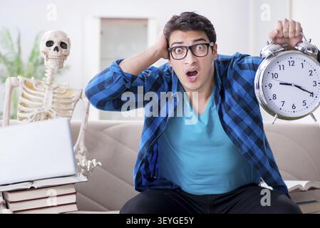Student studying with skeleton preparing for exams Stock Photo