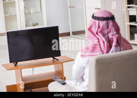 Arab businessman watching tv at home Stock Photo