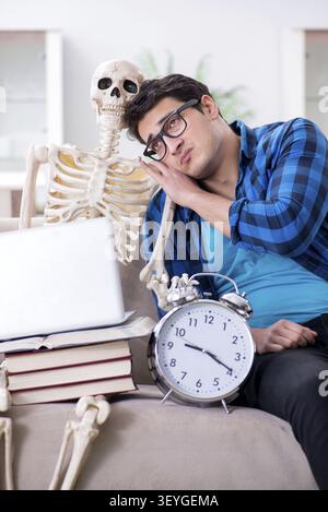 Student studying with skeleton preparing for exams Stock Photo