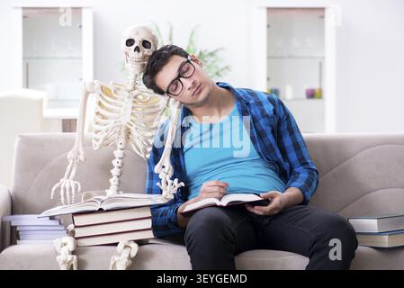 Student studying with skeleton preparing for exams Stock Photo