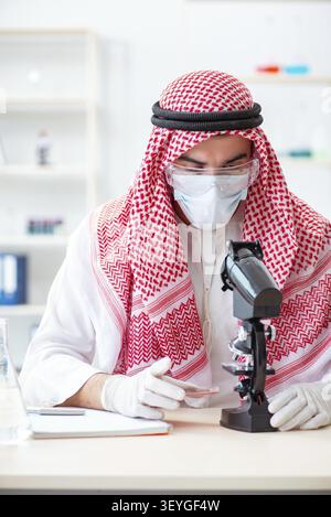 Arab doctor chemist studying new virus in lab Stock Photo