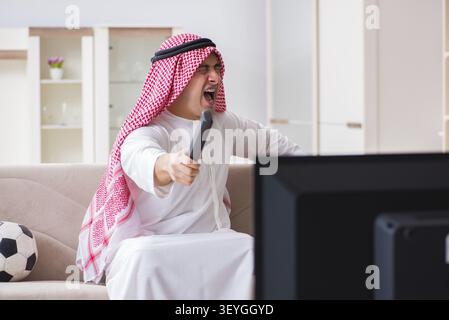 Arab businessman watching tv at home Stock Photo