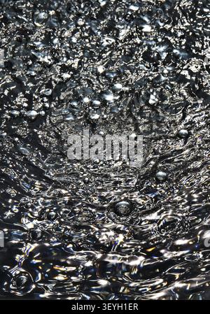 Air bubbles on dark water surface Stock Photo