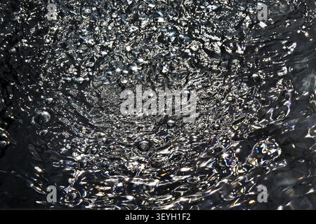 Air bubbles on dark water surface Stock Photo