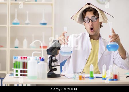 Funny crazy chemist doing experiments and tests Stock Photo