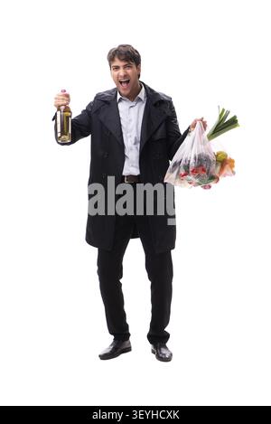 Young handsome man with vegatables in shopping concept Stock Photo