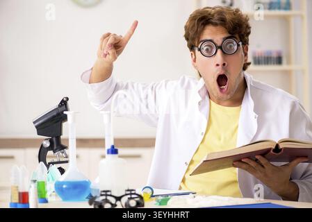 Funny crazy chemist doing experiments and tests Stock Photo