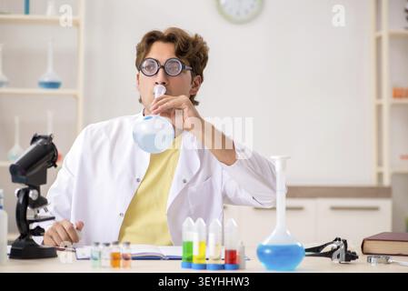 Funny crazy chemist doing experiments and tests Stock Photo