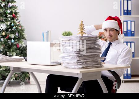 Young worker working in office on christmas shift Stock Photo