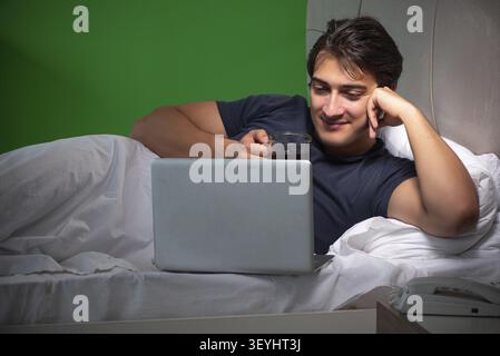Young handsome man suffering from insomnia at home Stock Photo