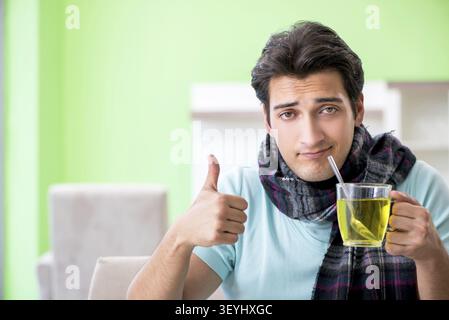 Young handsome man suffering from illness at home Stock Photo