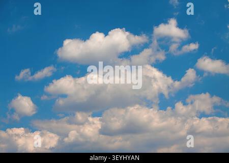 Mainz, Rhineland-Palatinate, Germany: White cumulus clouds floating across a deep blue summer sky Stock Photo