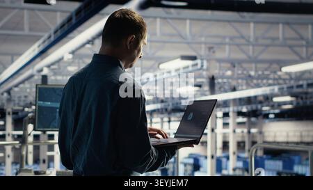 Data center engineer reviews artificial intelligence systems and machine learning processes inside a data center. Stock Photo