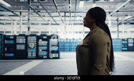 Data center manager oversees programmers reviewing AI diagnostics and machine learning systems. Stock Photo