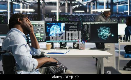 Man in wheelchair dissatisfied with data center AI analytics metrics. Stock Photo