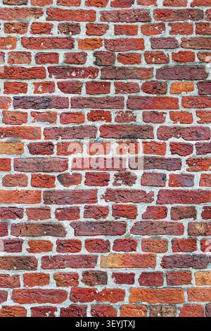Full-frame red brick wall with light mortar joints and regular masonry pattern for texture or background use. Stock Photo