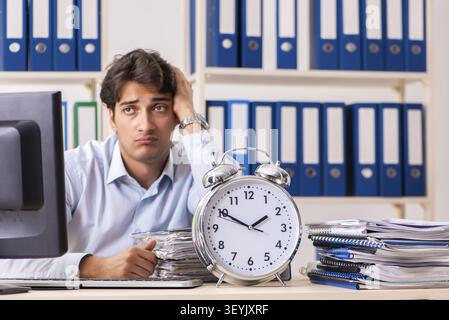 Overloaded busy employee with too much work and paperwork Stock Photo