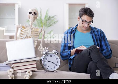 Student studying with skeleton preparing for exams Stock Photo