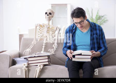 Student studying with skeleton preparing for exams Stock Photo