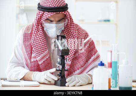 Arab doctor chemist studying new virus in lab Stock Photo